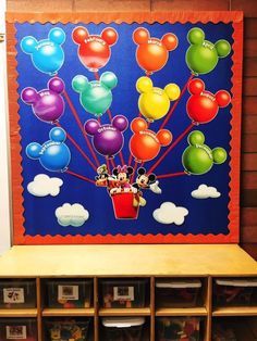 a mickey mouse bulletin board with balloons on it