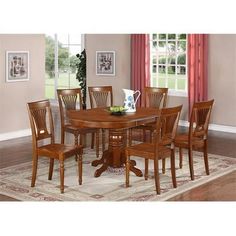 a dining room table and chairs with a rug on the floor in front of it