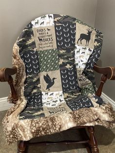 a chair with a blanket on it that has deers and birds printed on it