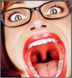 a woman with her mouth open and glasses on is making a funny face for the camera