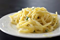 a white plate topped with pasta and sauce