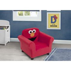 a red chair with an elmo face on it in a child's room