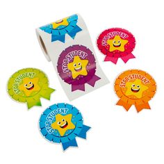 four stickers with different colors and designs on them, one has a smiling face