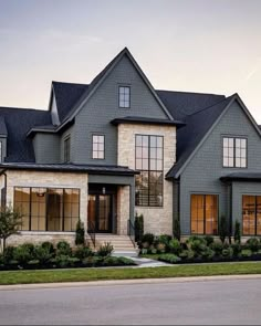 a large gray house with lots of windows