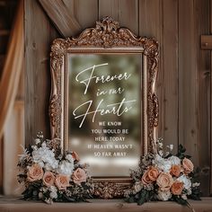 an ornate gold frame with flowers in front of it that says, forever in our hearts