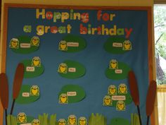 a bulletin board is decorated with owls and grass