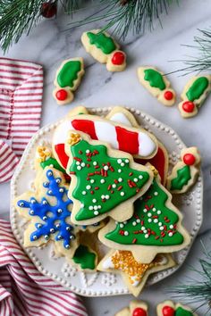 decorated christmas cookies on a plate with candy canes