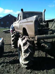 a large truck is parked in the mud