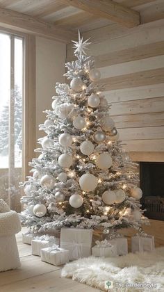 a white christmas tree with silver and white ornaments