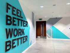 a sign that says, feel better work better on the side of a blue and white wall