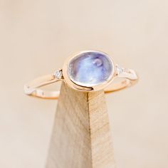 Product Details Ring Style: The "Sasi" is an oval cabochon moonstone women's engagement ring with... 14k Gold Engagement Ring, Staghead Designs, Moonstone Engagement, Pearl Details, Moonstone Engagement Ring, Ceramic Rings, Ring With Diamond, Detailed Ring, Tungsten Ring