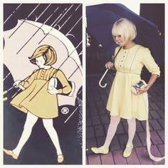 a woman in yellow dress holding an umbrella and standing next to a drawing of a girl