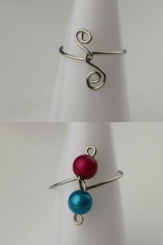 two rings with different colored beads are shown on top of each other, and one has a wire wrapped around it