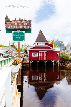 a red building sitting on the side of a river