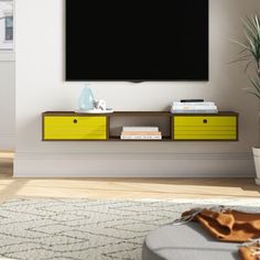 a flat screen tv mounted to the side of a wall in an empty living room