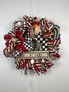 a wreath that says farm sweet farm on the front and side with an image of a rooster