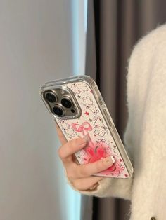 a woman holding an iphone case with hello kitty design on the front and back sides