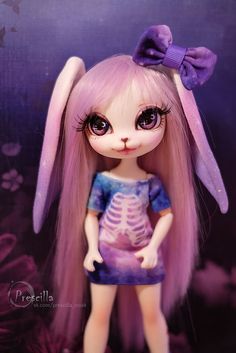 a doll with long pink hair and big eyes