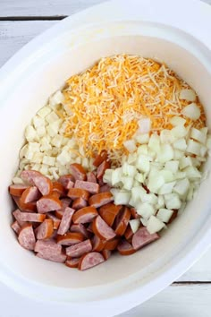 the ingredients for this meal are mixed together in a white bowl on top of a wooden table