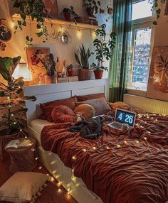 a bed room with a neatly made bed and lots of plants