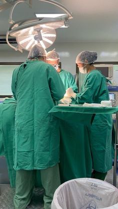 two surgeons in scrubs are preparing to perform surgery on a patient's back