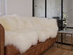 a white fur covered couch in a living room