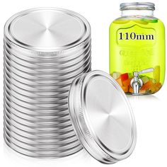 a stack of round tins next to a jar of liquid