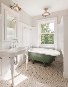 a bathroom with a claw foot tub and sink