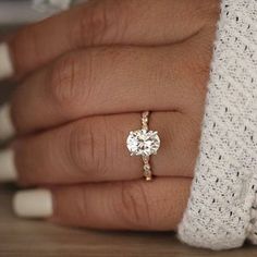 a woman's hand with a diamond ring on it