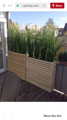 a wooden planter sitting on top of a wooden deck