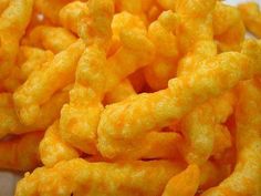 cheetos are piled on top of each other to make something look like it's made out of cheese