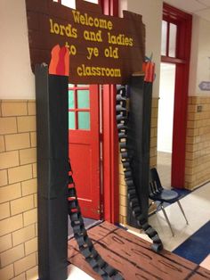 a sign that is in the middle of a room with some chairs and a door