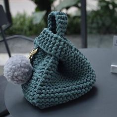 a crocheted purse sitting on top of a table