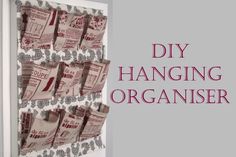 the hanging organizer is made out of old newspaper strips and has red writing on it