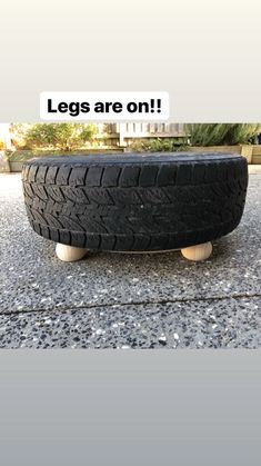 there is a tire on the ground with wheels and an inscription that says legs are on