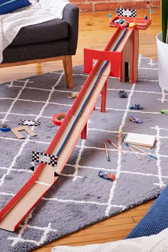 a child's toy race track set in a living room