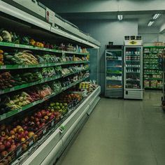 an aisle in a grocery store filled with lots of fresh fruits and veggies