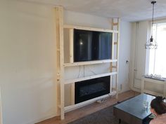 a living room with an entertainment center built into the wall