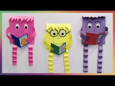 three paper monsters reading books and eating donuts