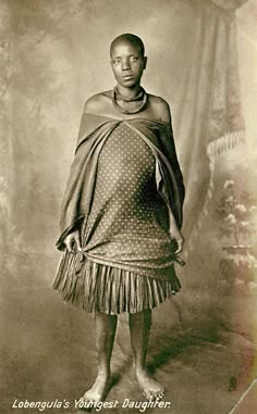 an old photo of a woman in native clothing