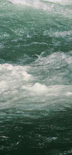 a man riding a surfboard on top of a wave in the ocean