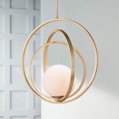 a light fixture hanging from a ceiling in a room with white walls and flooring