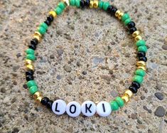 a beaded bracelet with the word look spelled in white and green beads on it