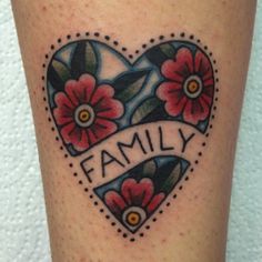 a heart tattoo with flowers and the word family on it