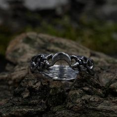 a silver ring sitting on top of a rock