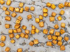 some food that is laying out on a counter top and has been cut up into cubes