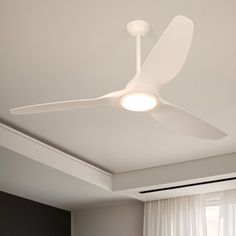 a white ceiling fan mounted to the ceiling in a bedroom