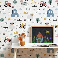 there is a wallpaper with cars and trucks on it in the room, next to a chalkboard