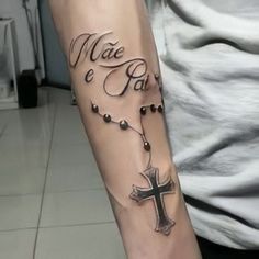 a man with a cross tattoo on his arm