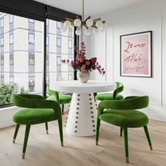 a dining room with green chairs and a white table